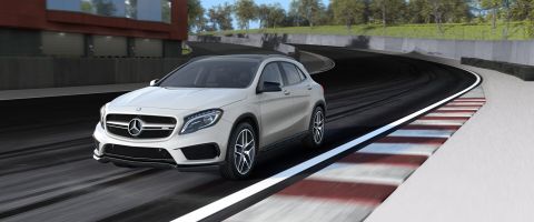 1995 Ford Bronco - White Mercedes-Benz GLA-Class SUV on a race track with blurred background.