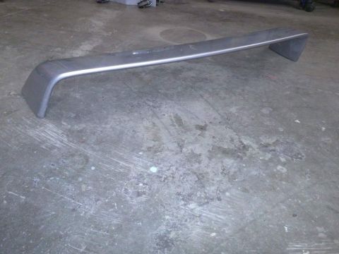 2002 Volkswagen Jetta - A gray rear spoiler with silver trim is shown on a concrete surface.