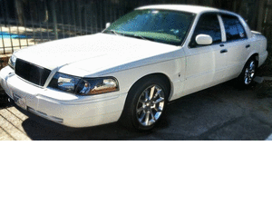 2000 Mercury Grand Marquis - A white 2000 Mercury Grand Marquis sedan is viewed from the front passenger side.