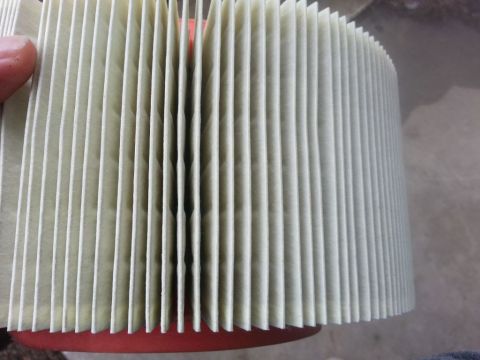 2008 Hyundai Accent - Close-up view of a vehicle air filter, showing its pleated paper element and red rubber seal. The registry claims it is from a 2008 Hyundai…