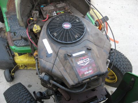 2006 Honda RANCHER - A close-up view of a dirty lawn tractor engine, showing the Briggs & Stratton 20 HP V-Twin OHV label.