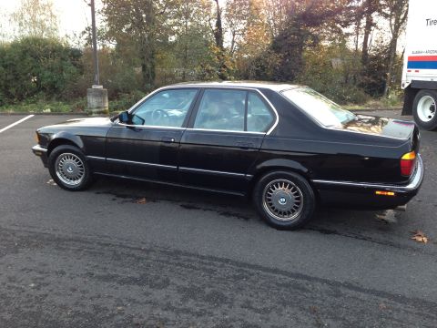 1988 BMW 7 Series - Side view of a black 1988 BMW 7 Series sedan.