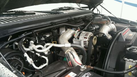 2003 Ford Excursion - The engine bay of a large truck or SUV is shown with the hood open.