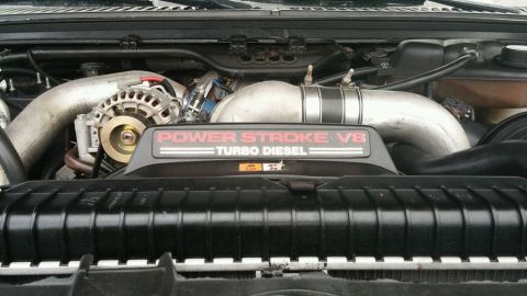 2003 Ford Excursion - Close-up of a vehicle's engine bay, showing the "Power Stroke V8 Turbo Diesel" engine cover.