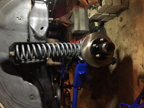 1994 Ford Bronco - The front suspension and brake assembly of a vehicle is shown, possibly undergoing maintenance or repair.