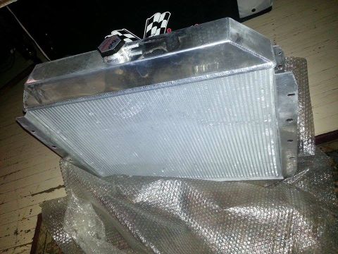 1979 Ford Bronco - An aluminum radiator with checkered flags and a cap is shown, likely for an engine build.
