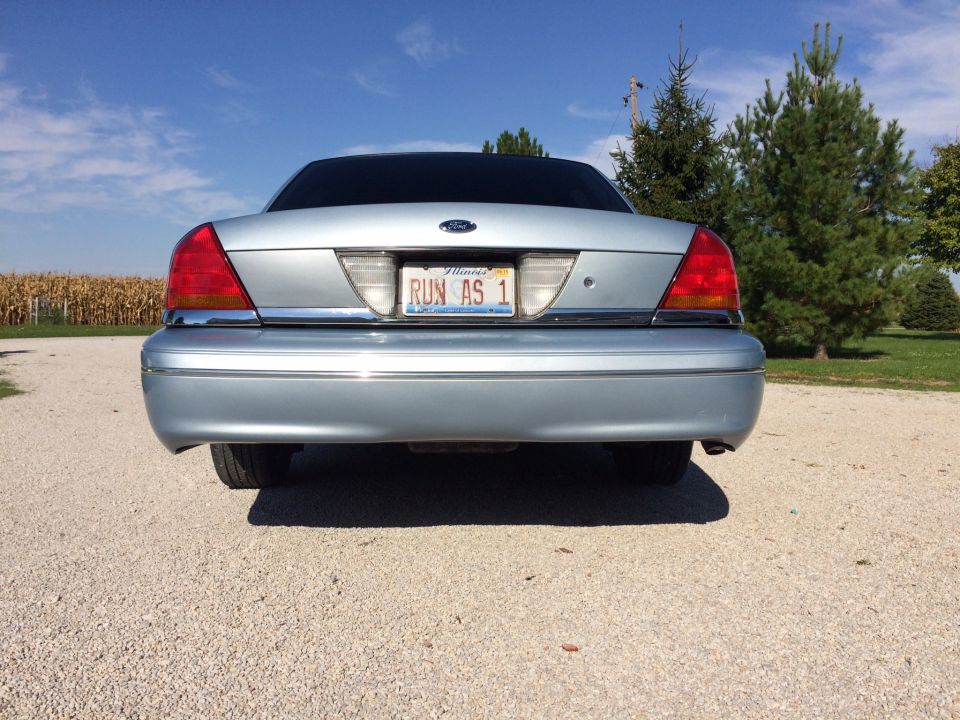 2003 Ford Crown Victoria rear view, silver paint, Illinois license plate 'RUN AS 1'