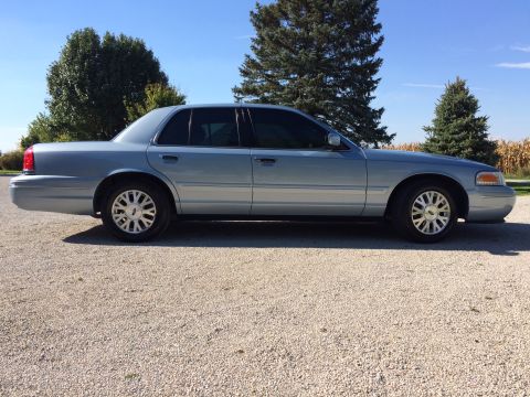 2003 Ford Crown Victoria - Light blue 2003 Ford Crown Victoria shown from the side on a sunny day.
