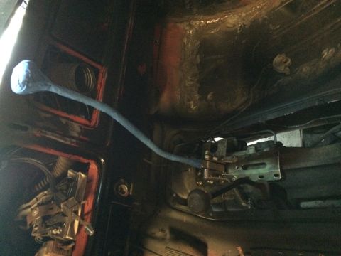 1978 Ford Bronco - Close-up view of the transmission shifter linkage and its housing within a vehicle's interior.