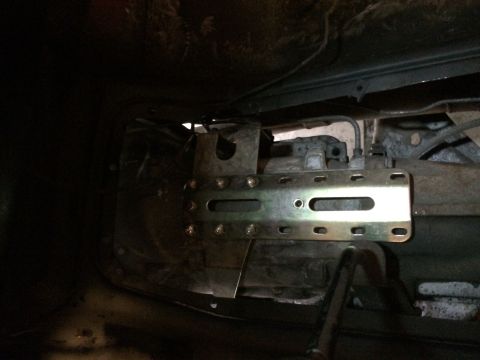 1978 Ford Bronco - Transmission assembly with a newly installed bracket, viewed from underneath.