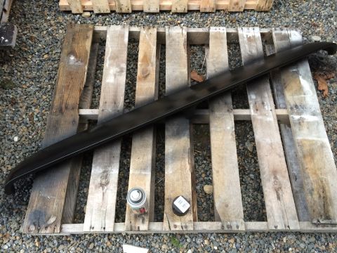 1978 Ford Bronco - A black car spoiler rests on wooden pallets, with a spray can nearby.
