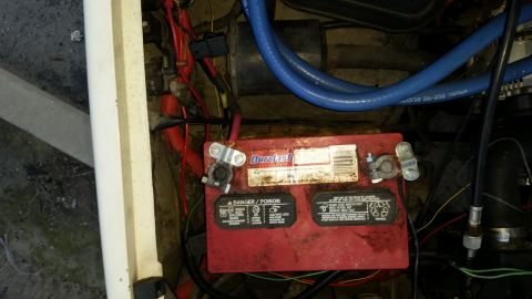 1991 Ford F-250 - Close-up view of a vehicle's engine bay, focusing on the battery and associated wiring.
