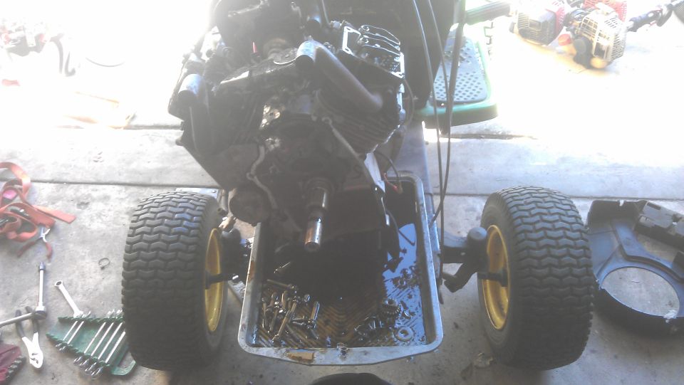 Lawn mower V-twin engine with oil pan removed, showing internal parts