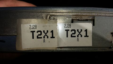 1991 Ford F-250 - Two identical labels are affixed to a metal electronic control unit, likely for a vehicle.