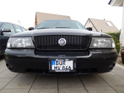2003 Mercury Marauder - The front of a black Mercury Marauder is shown, its distinctive vertical grille and headlights.