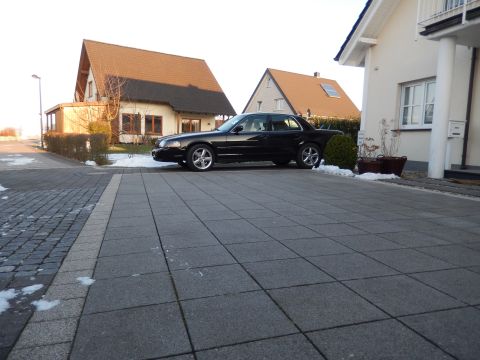 2003 Mercury Marauder - A black 2003 Mercury Marauder is parked on a paved driveway in front of a residential house.