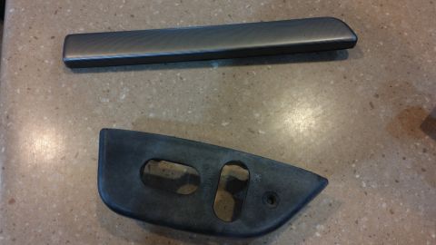 1995 Ford Bronco - Two dark gray interior trim pieces are shown on a speckled countertop.