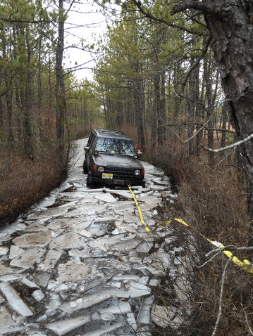 1987 Toyota 4Runner - A dark 1987 Toyota 4Runner is stuck on a treacherous icy road in Wharton State Forest, with a tow strap attached.