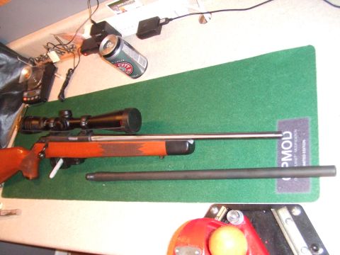 1996 Ford Bronco - Rifle with scope and extra barrel laid out on a green mat, with electronics and a beer can nearby.