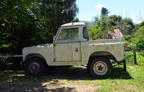 1969 Lincoln Continental - A vintage pickup truck sits idle in a natural outdoor setting, showing signs of age and wear.