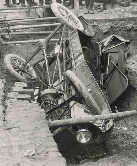 1915 Ford Model T - A 1915 Ford Model T has ended up in a ditch, its wheels pointing skyward.