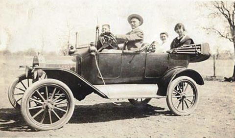 1915 Ford Model T - A family poses for a photo in a 1915 Ford Model T touring car on a sunny day.