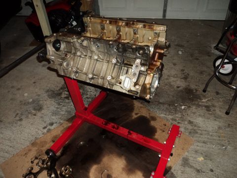 2004 Mercury Grand Marquis - Engine block on a red stand in a garage setting.