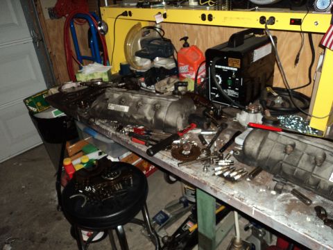 2004 Mercury Grand Marquis - Engine components and tools are laid out on a workbench, with a welding machine in the background.