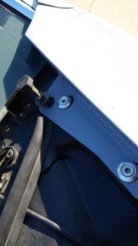 1976 Ford Ranchero - Detail of a hood latch mechanism, showing bolts and washers, with a watermark for Supermotors.net.