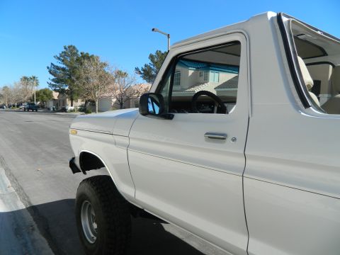 1979 Ford Bronco - Side view of a white Ford Bronco, likely a 1978 model, parked on a suburban street.