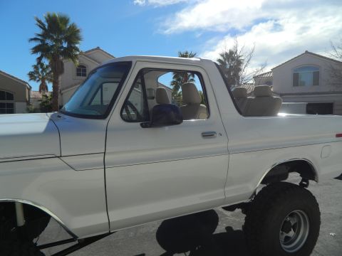 1979 Ford Bronco - This 1978 Ford Bronco is shown from the side, a lifted suspension and tan interior.