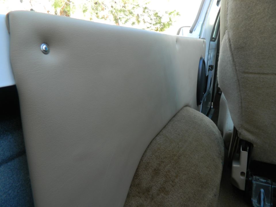 Tan interior door panel with speaker visible