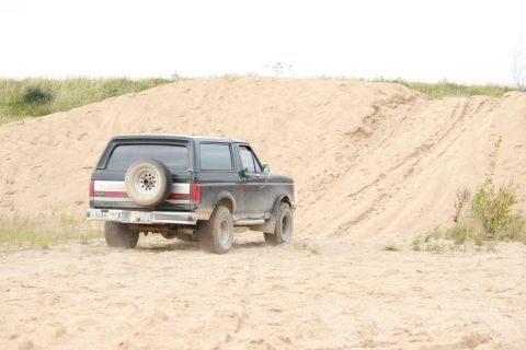 1987 Ford Bronco - This 1987 Ford Bronco navigates a sandy terrain, its off-road capabilities.