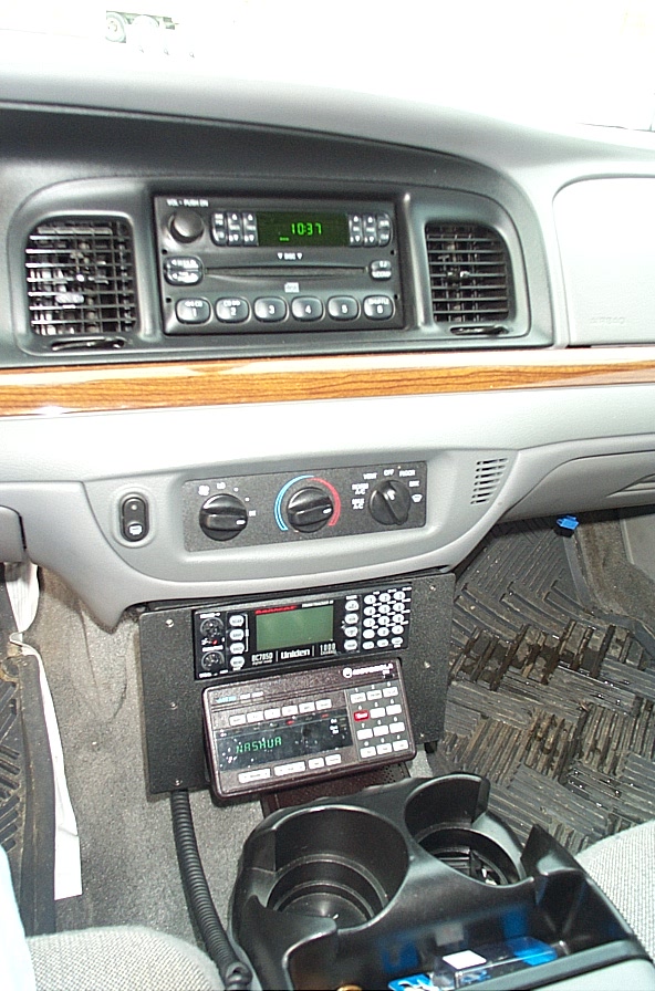 Car interior with two-way radios and cup holders