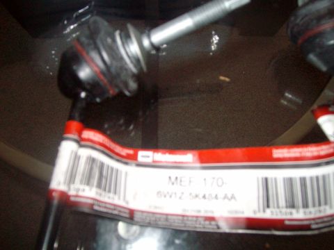 2004 Ford Crown Victoria - A close-up of a car part with a Ford label and barcode is shown.