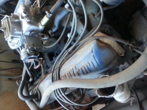 1973 Ford F-100 - Close-up of a blue Ford engine valve cover, possibly from a 1973 Ford F-100, showing a '302' badge.