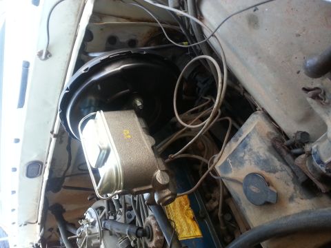 1973 Ford F-100 - Underside view of the brake master cylinder and booster assembly, showing brake lines and wiring.