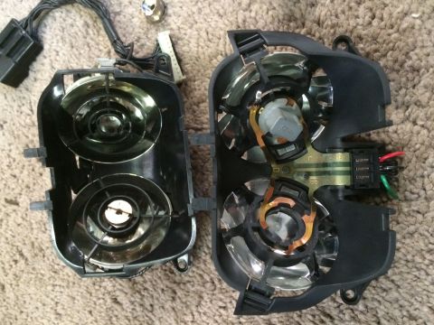 1993 Ford Bronco - Disassembled headlight assemblies, showing internal components and wiring, likely for a vehicle part replacement or repair.