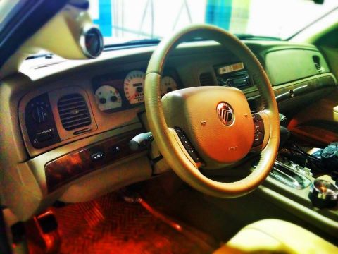 2000 Mercury Grand Marquis - Interior view of a 2000 Mercury Grand Marquis, showing the dashboard, steering wheel, and center console details.