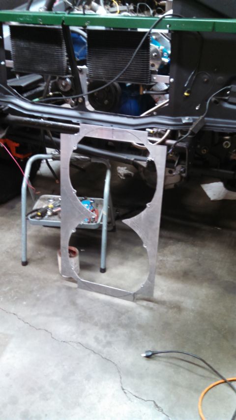 1967 Ford F-250 - A custom-fabricated aluminum shroud for dual fans sits on the garage floor, ready for installation in a vehicle project.