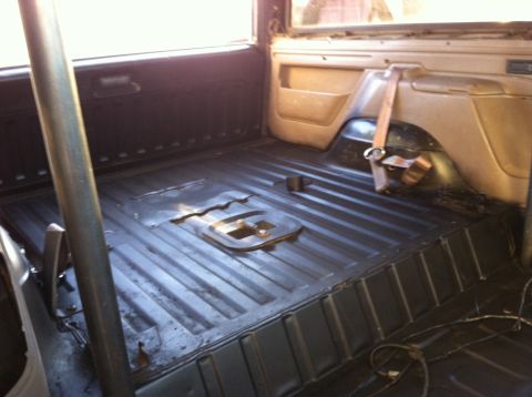 1995 Ford Bronco - Interior view of a vehicle's cargo area showing the floor and a roll cage bar.