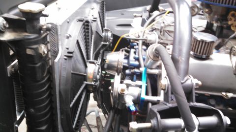 1967 Ford F-250 - The engine bay features a large radiator and an electric cooling fan, with various hoses and engine parts visible.