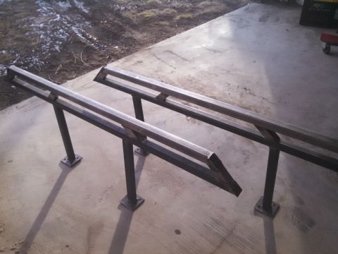 1991 Ford Bronco - Two custom metal ramps are shown on a concrete surface.