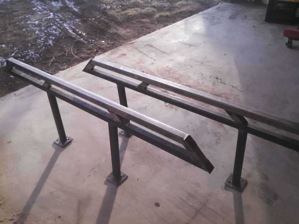 Two metal ramps with square bases and double horizontal bars