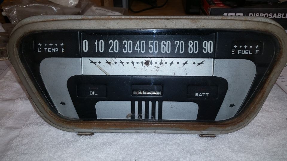 Vintage dashboard gauge cluster with speedometer, fuel, oil, and battery indicators