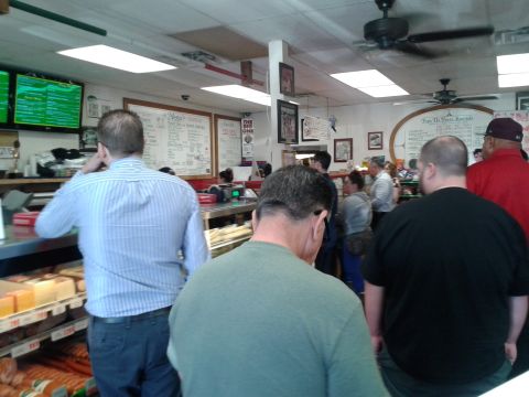 1990 Ford Bronco - Interior view of a busy deli with customers and staff.