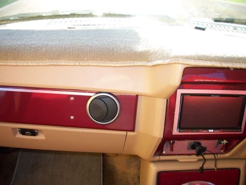 1985 Ford Bronco - The dashboard of a car shows a digital screen and air vents, with a website watermark at the bottom.