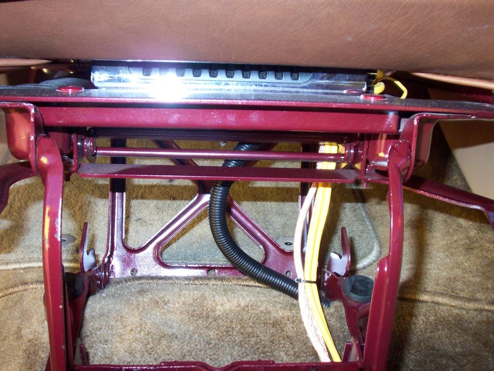 close-up of a car seat's metal frame and wiring