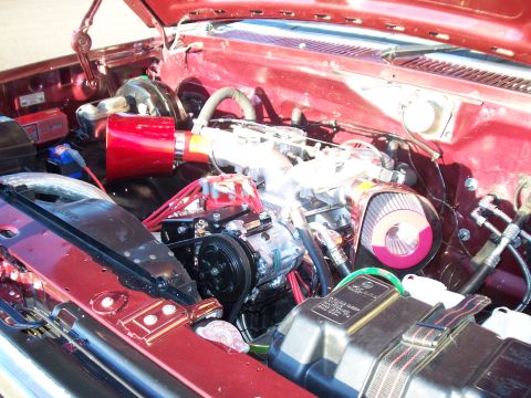 1985 Ford Bronco - Customized engine bay a red air filter and intake system.