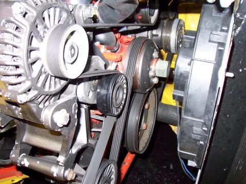 1985 Ford Bronco - Engine belt system with alternator, pulleys, and fan visible.